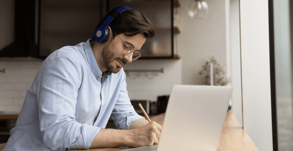 Business man writing notes while on a call