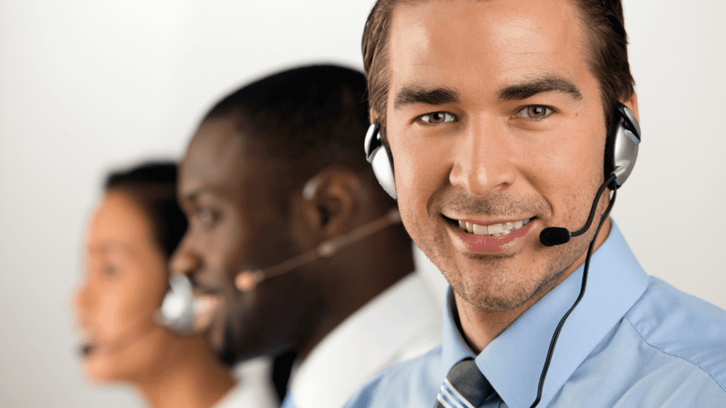 A smiling contact centre agent with headphones on