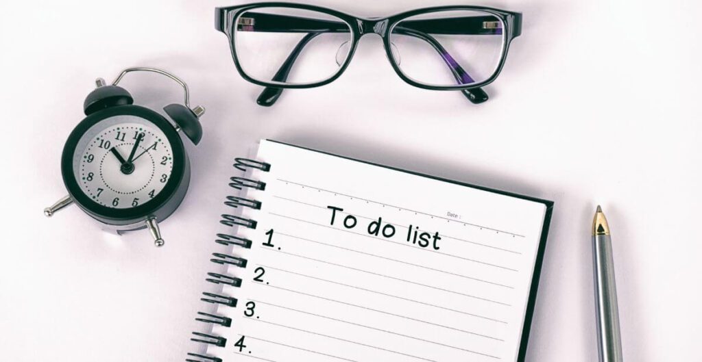 A flat lay of a desk with an open notebook with an empty to-do list - something task organisation apps can replace.