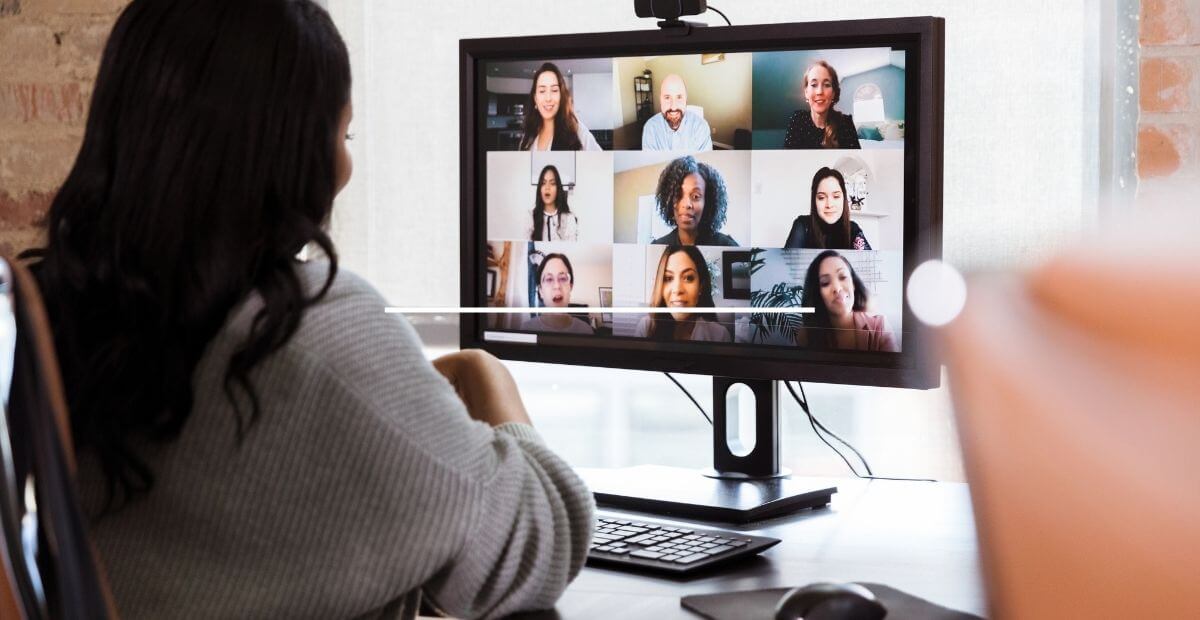 Google Meet - A woman facing her computer during a video call via a video meeting app