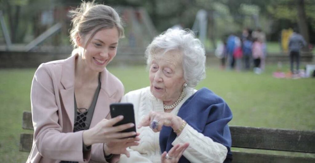 Cheerful ladies looking at mobile phones